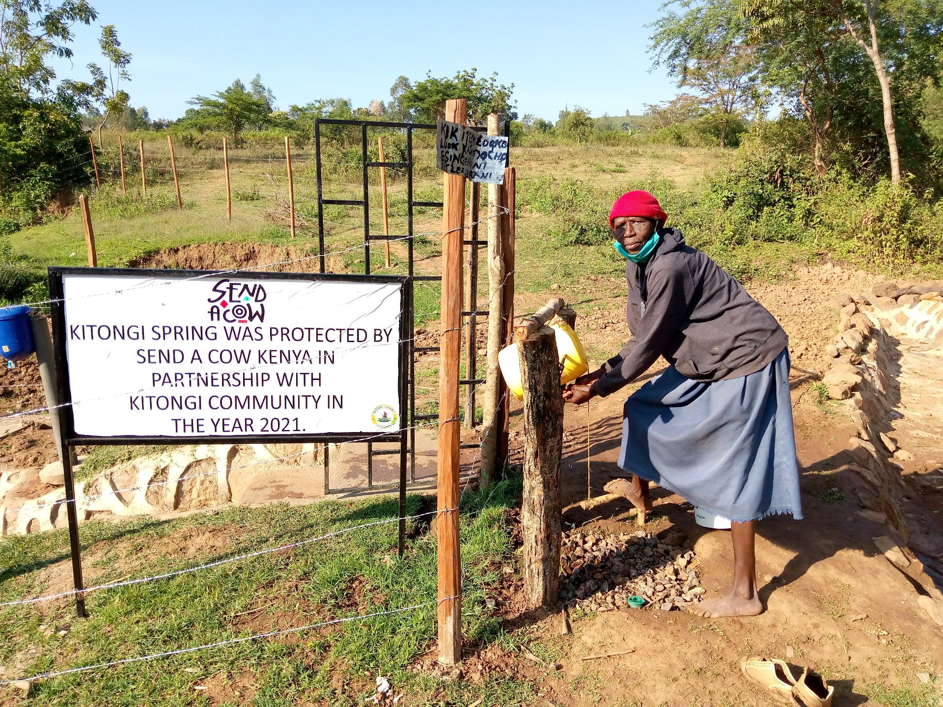 Dina Matheri using the Tip Tap before collecting water at Kitongi water point Kenya.jpg
