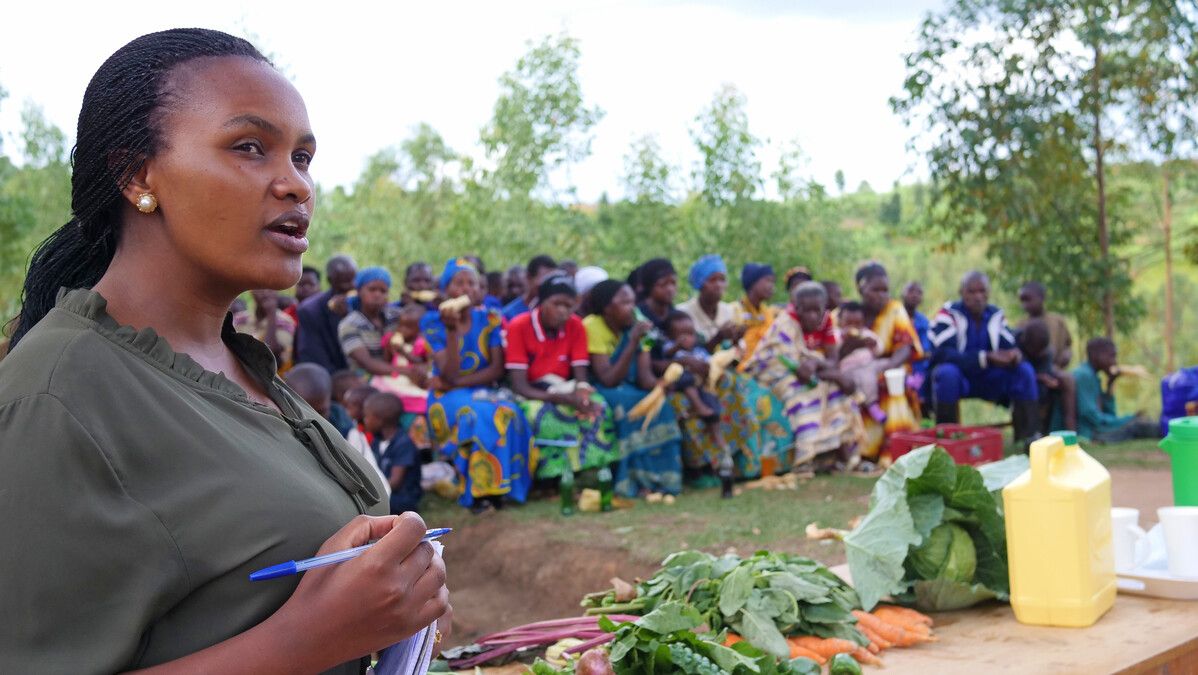 Local community leader Aline Nirere with the Urumuri self-help group supported by Send a Cow Rwanda (now Ripple Effect Rwanda).jpg