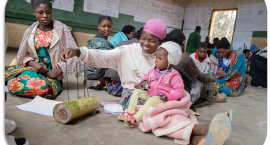 Learner with baby in a community-based accelerated learning centre, Malawi
